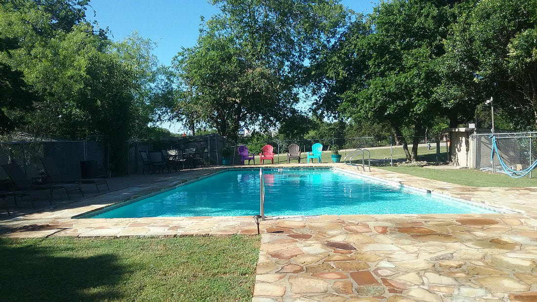 Resort-style pool and covered seating at Belton RV Park