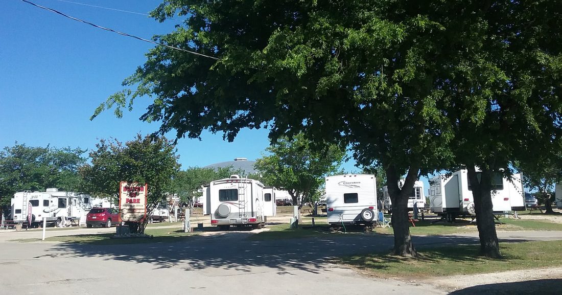 Spacious RV sites beneath mature trees at Belton RV Park